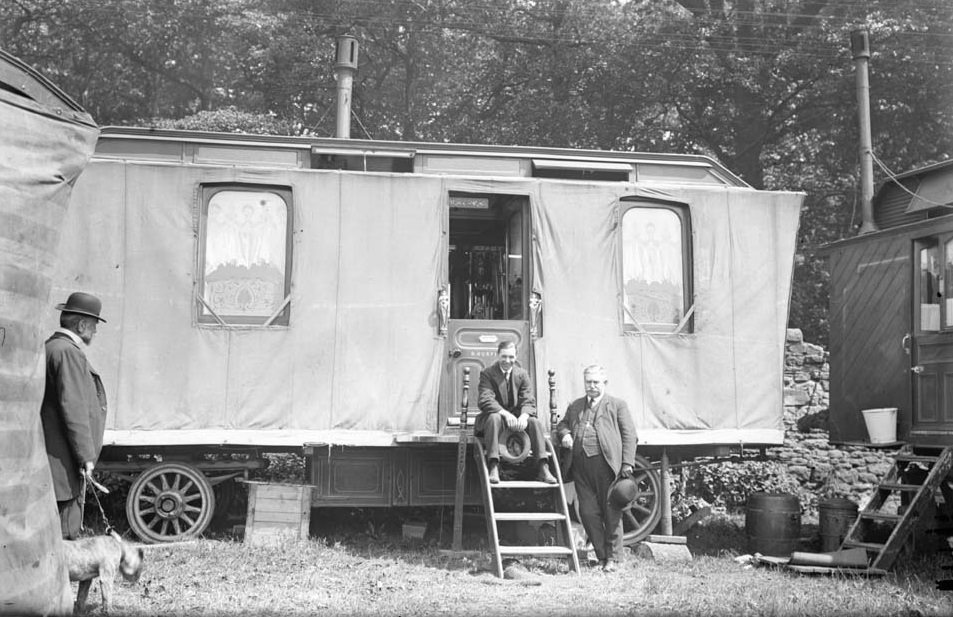 A.J.Fenwick sat on the steps of a showman's caravan