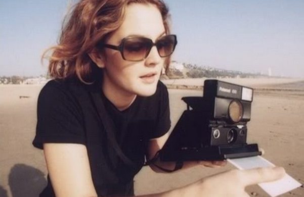 Drew Barrymore with a Polaroid