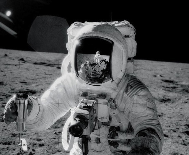 Buzz Aldrin shot by Neil Armstrong (who you can also see in the helmet reflection). Buzz is holding his Hasselblad and Neil is using one to take the photo.