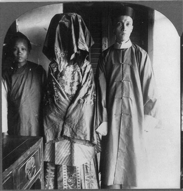 Seen here is one of the most widespread traditions of human society in any country, the wedding. The bride stands with her face covered, and indeed, it was quite normal for a groom not to see his bride before they were wed.