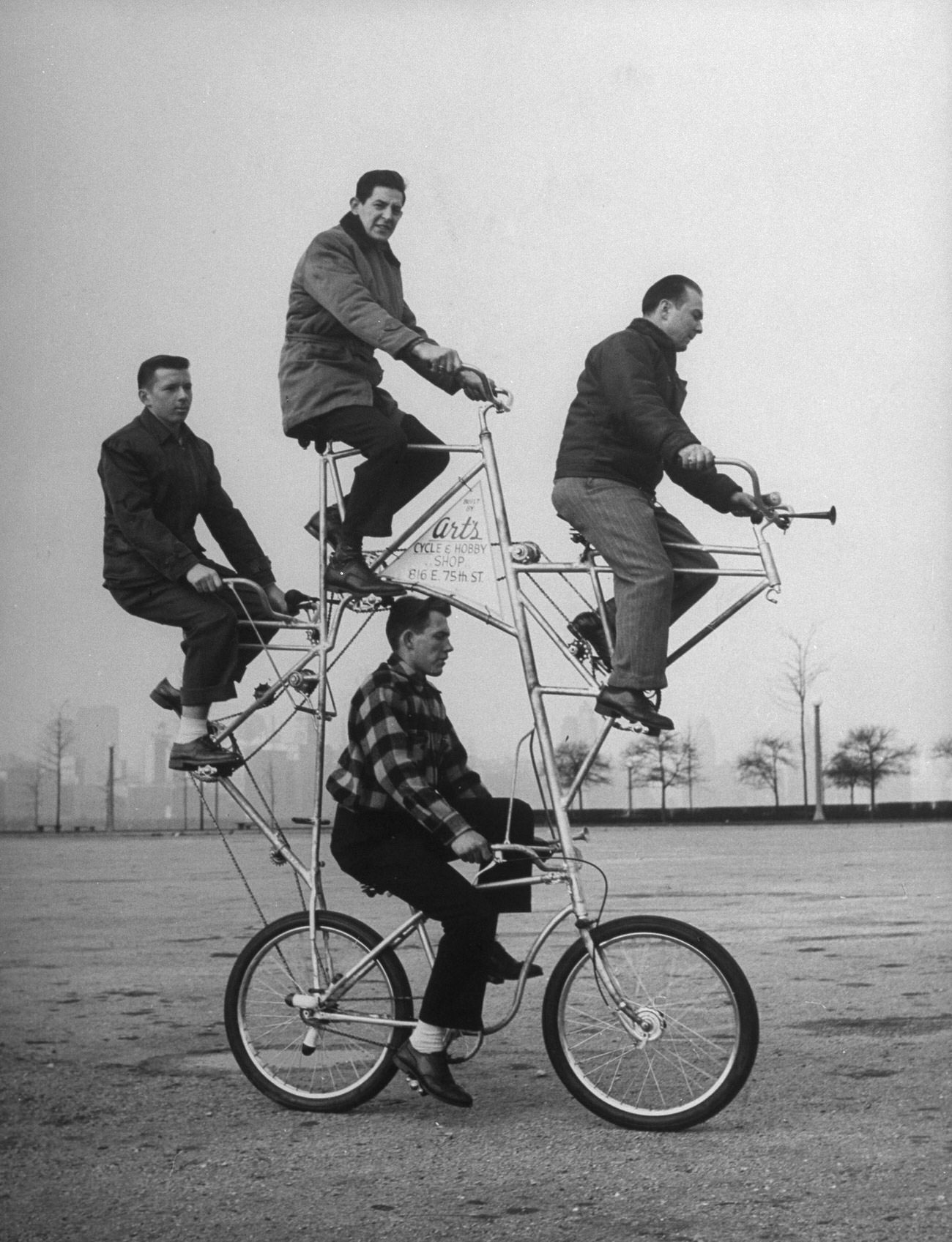 Four-man bicycle is powered by five chains and has brakes on both its wheels. The bike was built by Art Rothschild (top position) who broke three ribs while learning how to ride it.