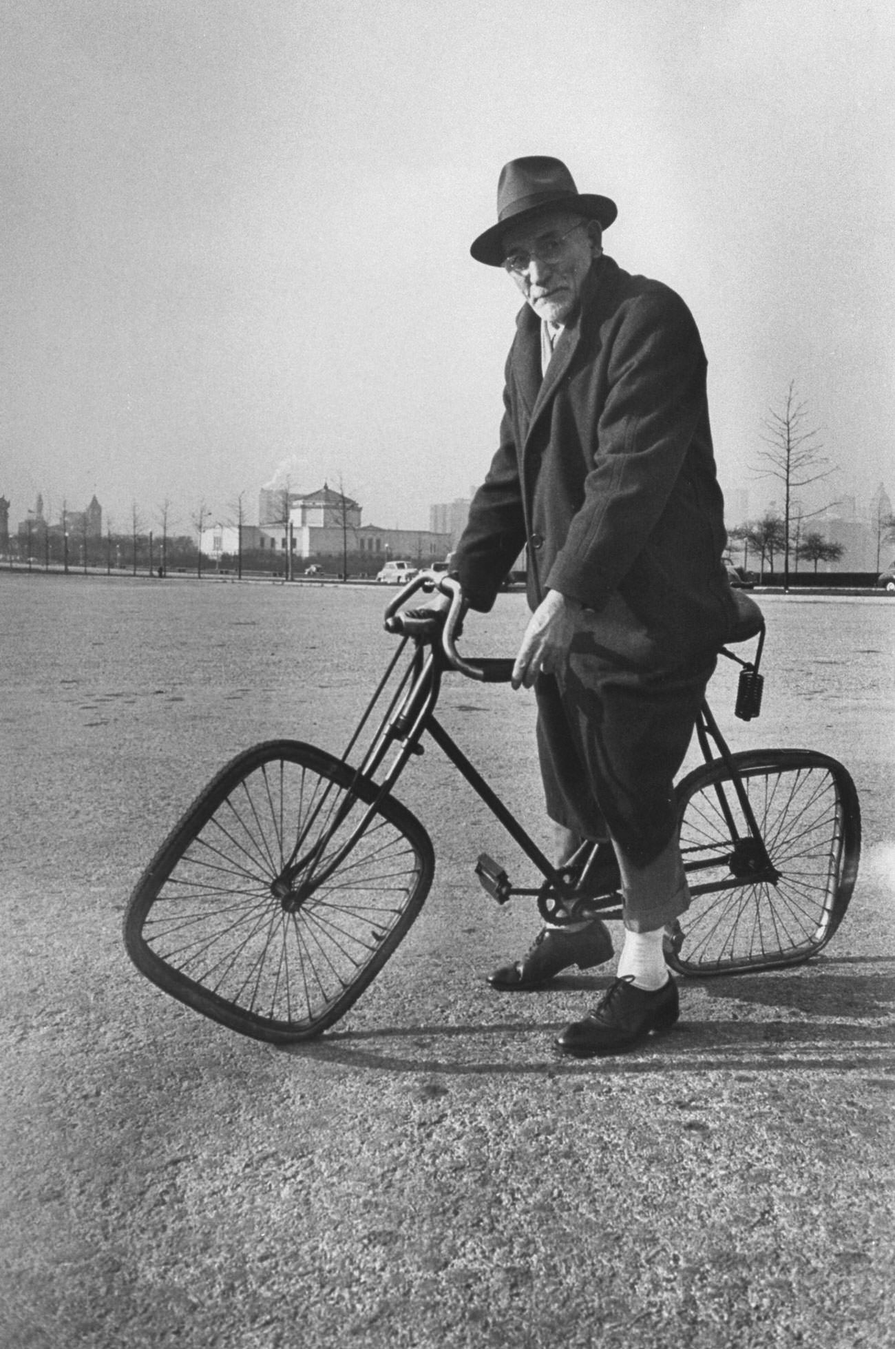 Square-wheeled bike held by Bernard Steinlauf was built by son Dave after seeing a bicycle wreck.