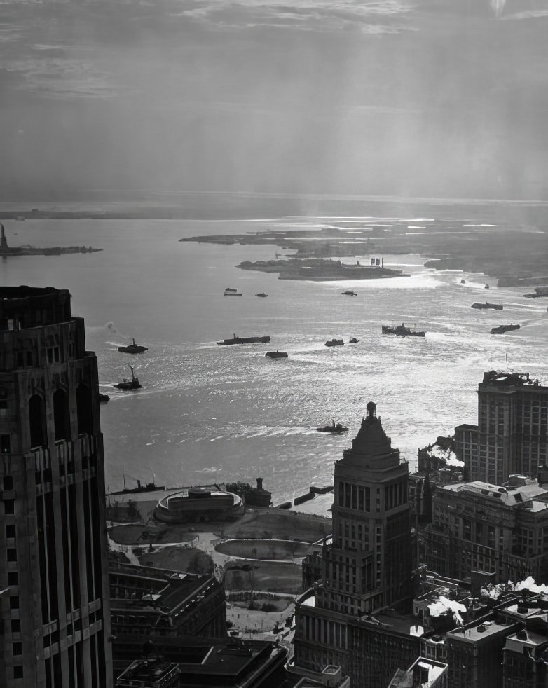 An aerial view of Battery Park and out across the sunlit waters of New York Harbor, 1946