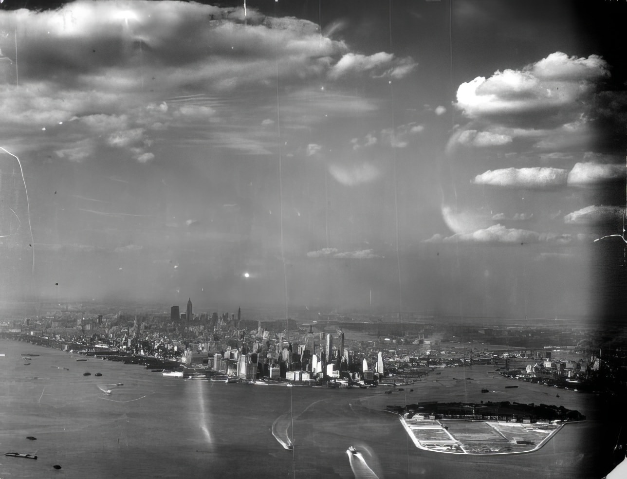 An aerial view, from the south, of Lower Manhattan, Governor's Island, the harbor, the Hudson and East Rivers and New York City's surroundings, 1939