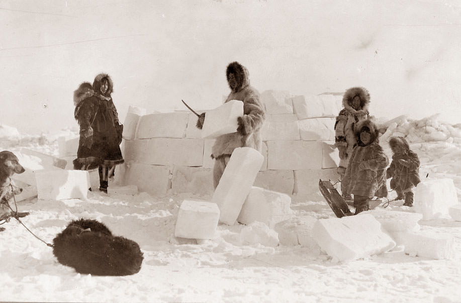 An Eskimo Family building an igloo, 1924