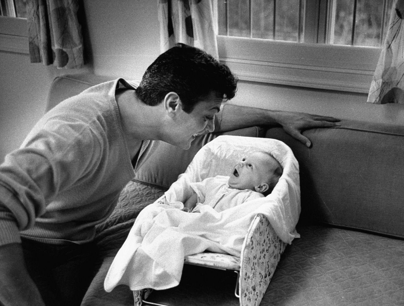 Tony Curtis smiles at his daughter, Jamie Lee, 1959.