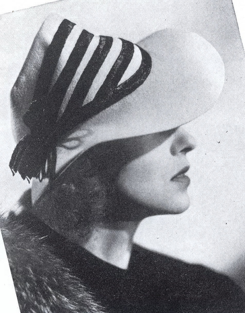 Frances Drake wearing a grey-blue felt hat trimmed with black straw braid, 1937