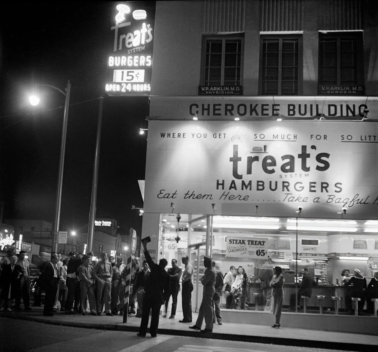 People gathered around Treats Hamburgers on Hollywood Boulevard in Hollywood, California, 1951.