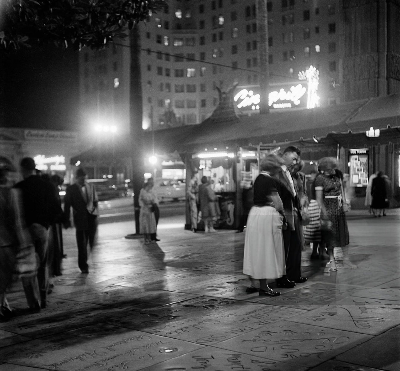 Tourists visiting the footprints at Mann's Chinese Theatre on Hollywood Boulevard in Hollywood, California, 1951.