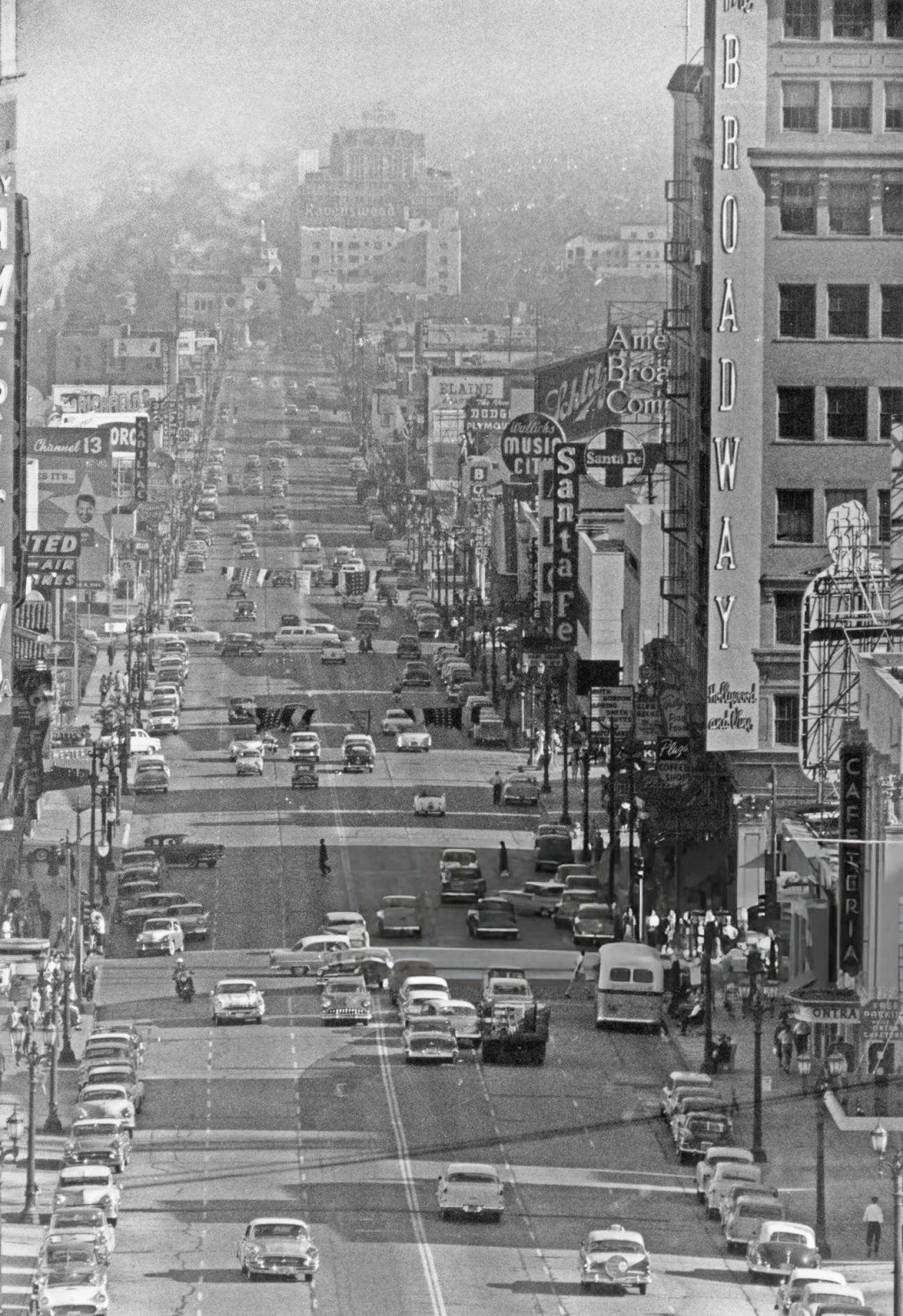 Pedestrians and traffic on Hollywood and Vine in Hollywood, California, 1955.