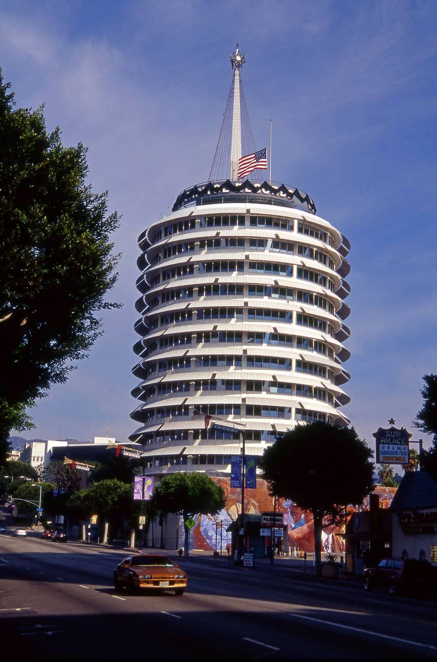 The Capitol Records building with a black band and flag at half-staff to commemorate the death of Beatle great George Harrison, in Hollywood, California, 1960s.