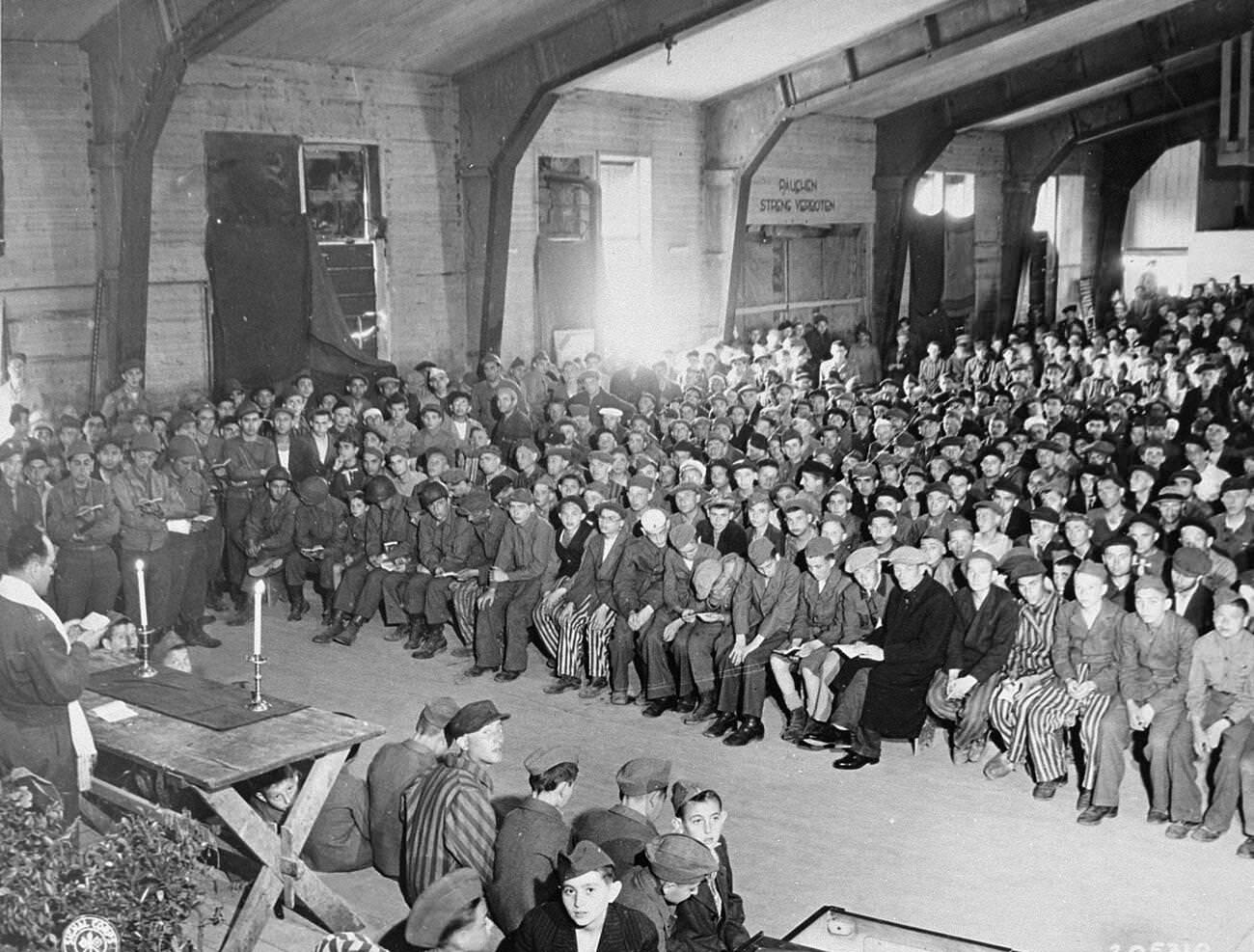 An American Rabbi conducting Shavuot services for the liberated survivors of Buchenwald concentration camp, 1945.