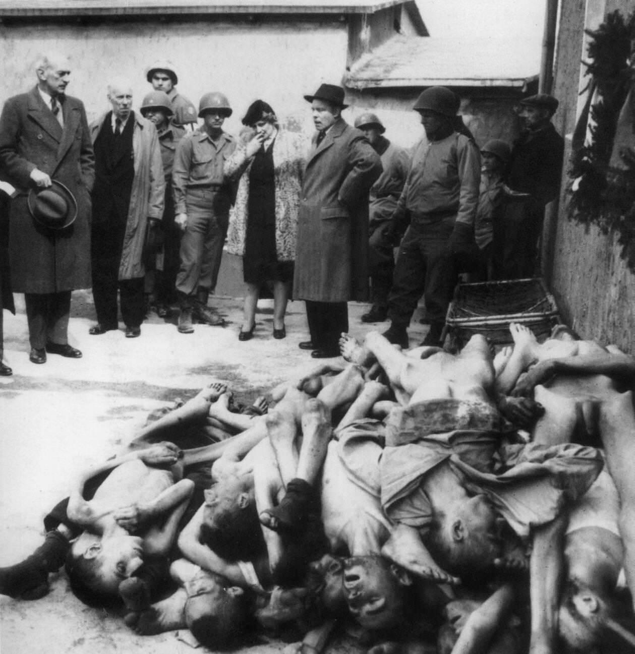 British MPs and journalists are shown corpses at the Nazi concentration camp after liberation, 1945.