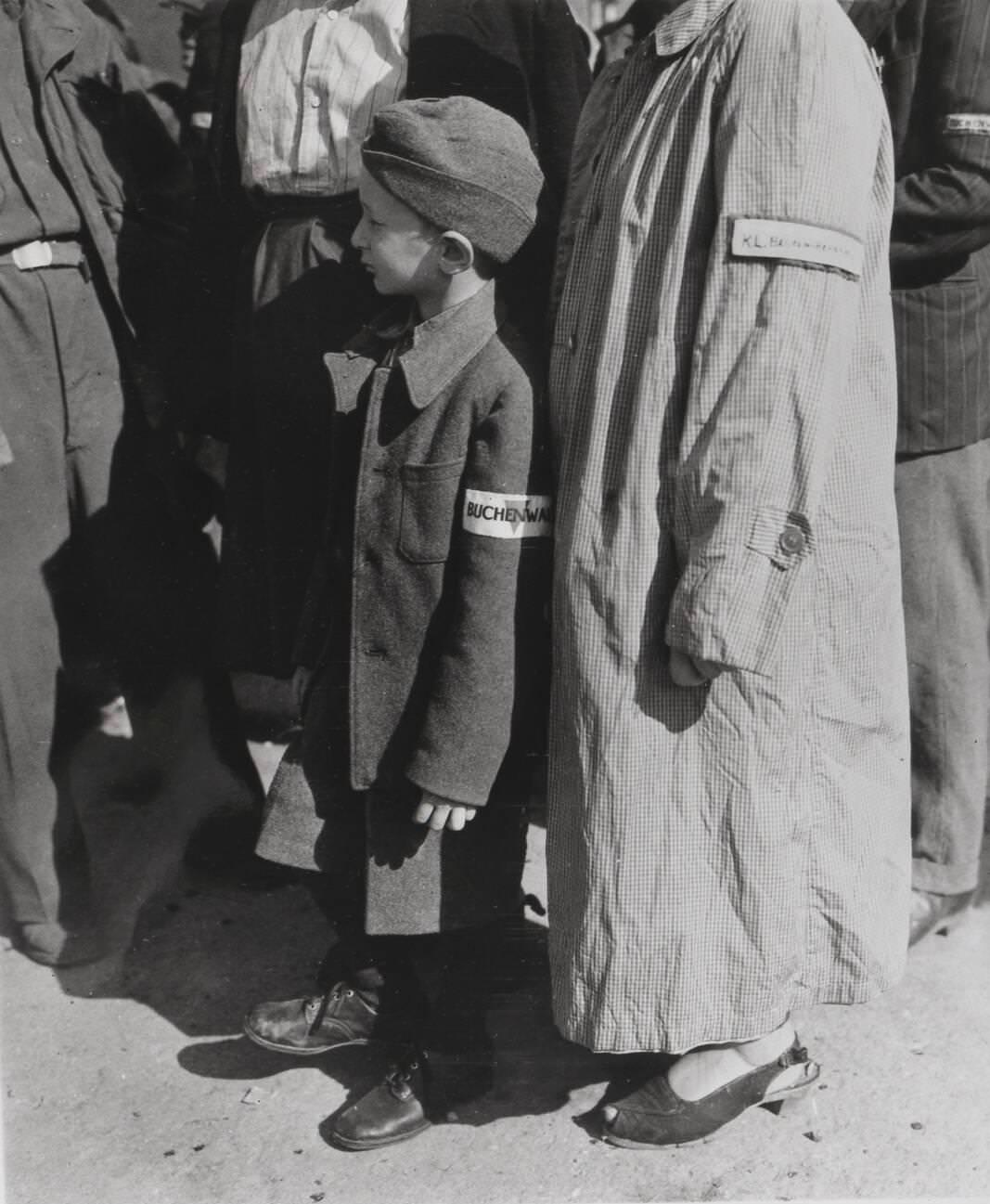 A 7 year old survivor of the Buchenwald concentration camp complex waiting to be processed after liberation of the camp, 1945.