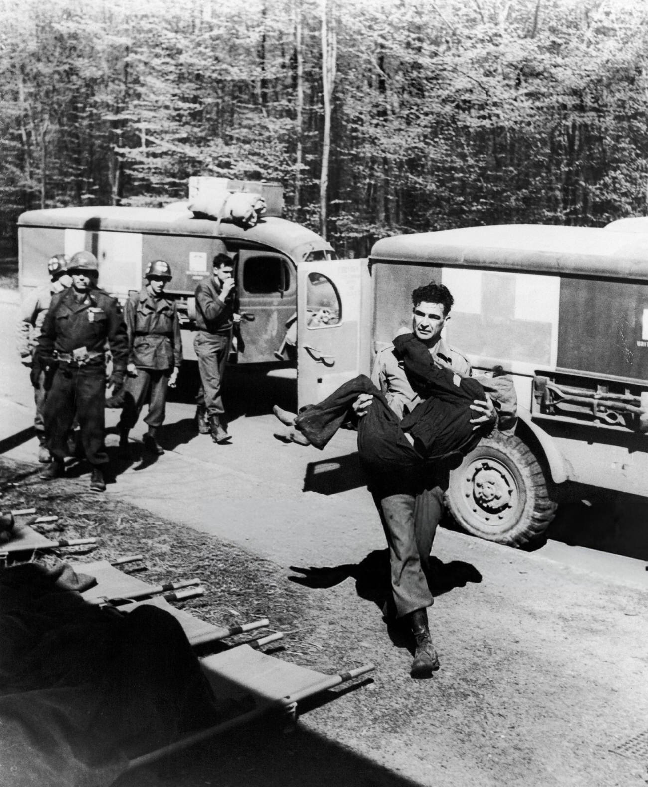 An American Soldier of the 6th Armoured Division Carrying a Hungarian Woman from the Ambulance to the Hospital, After the Liberation of the Camp of Penig-Langenleuba, Close To Altenbourg, Germany, 1945.