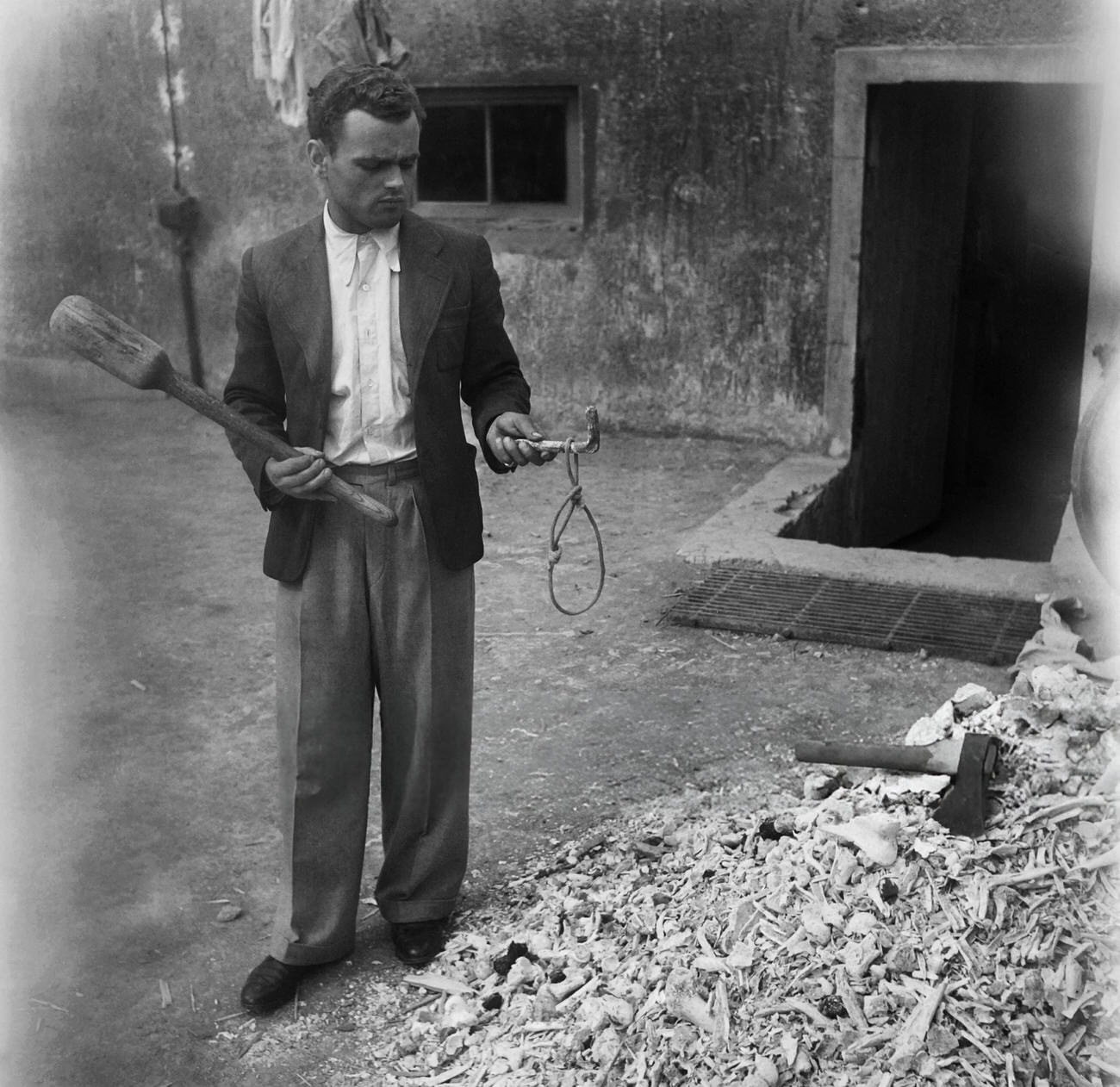 A man shows a noose used for hanging in the Buchenwald concentration camp, 1945.