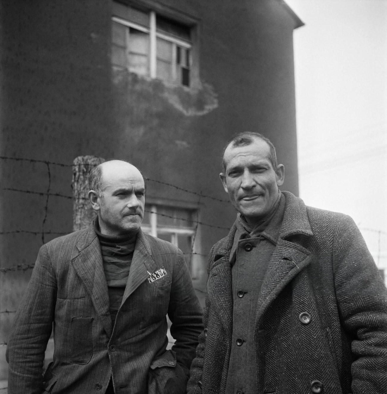 French prisoners Camille Sautereau and commander Bellon talk together in the courtyard of Nazi camp of Buchenwald, 1945.