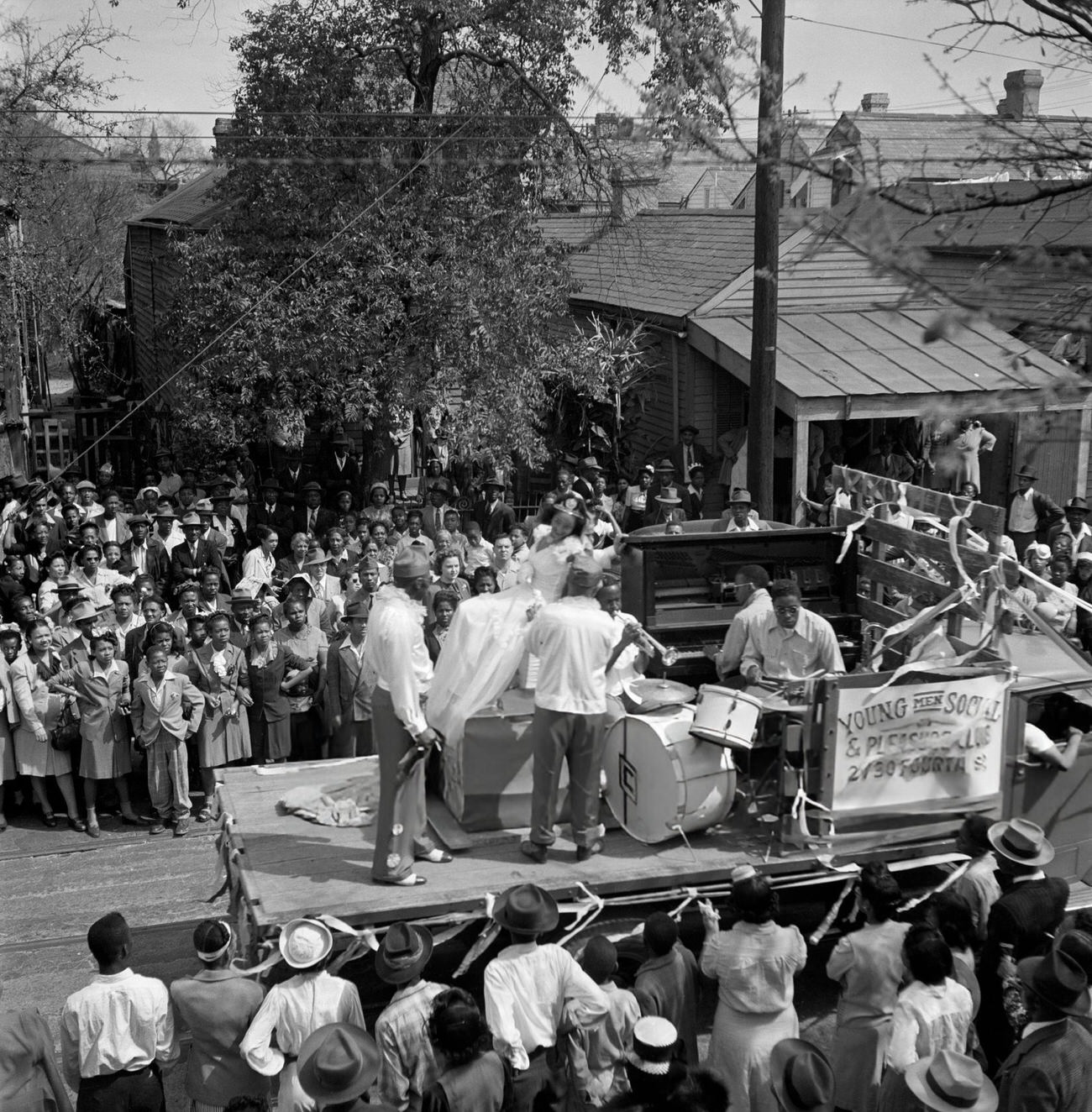 An African American Neighborhood Gathers to Watch a Mardi Gras Parade, 1950s.