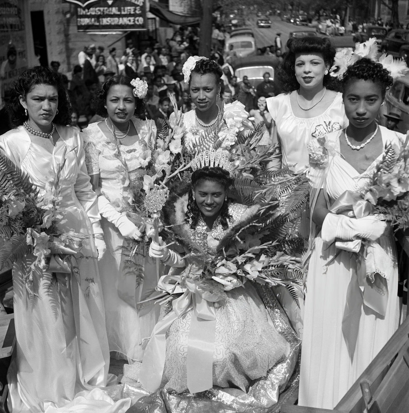 Six African-American Mardi Gras Princesses Ride a Parade Float in Their Formals, 1950s.