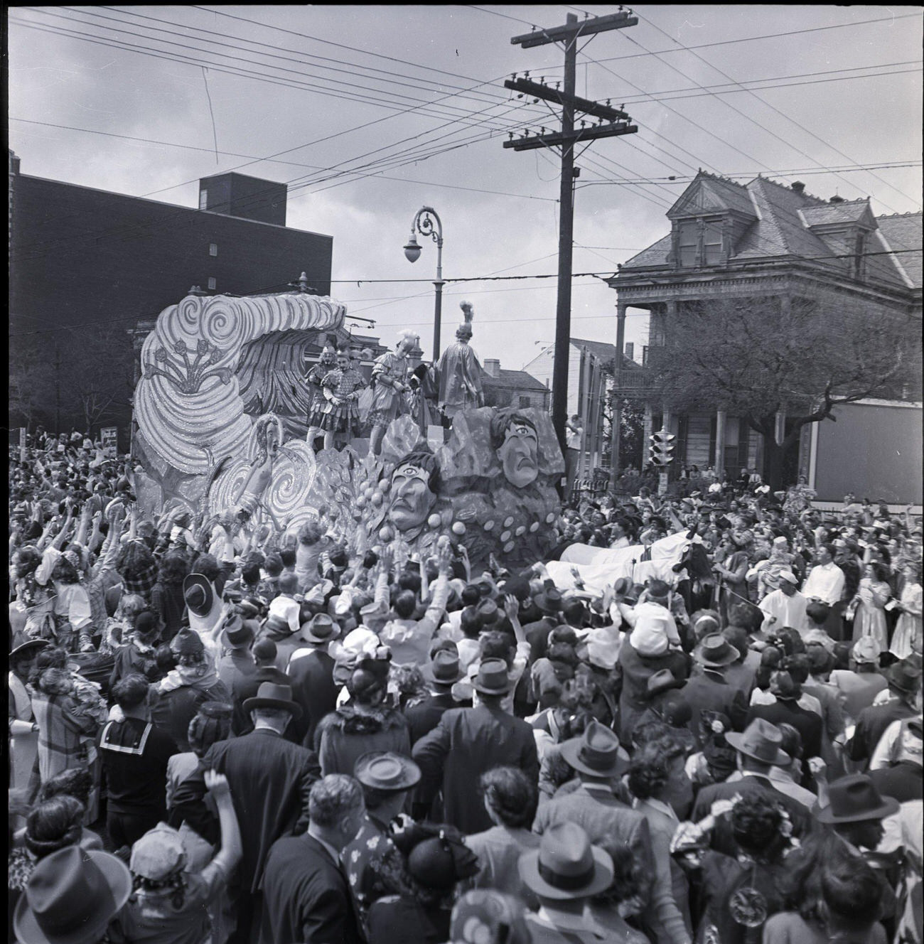 Crowds of Spectators Swarm Around a Mardi Gras Parade Float to Catch Beads and Candy, 1950s.