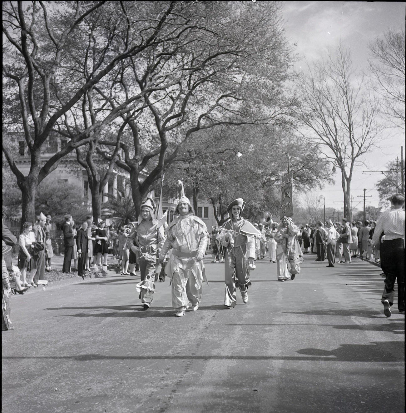 Spectators Line a Street to Watch a Mardi Gras Club Hold Their Costume Parade, 1950s.