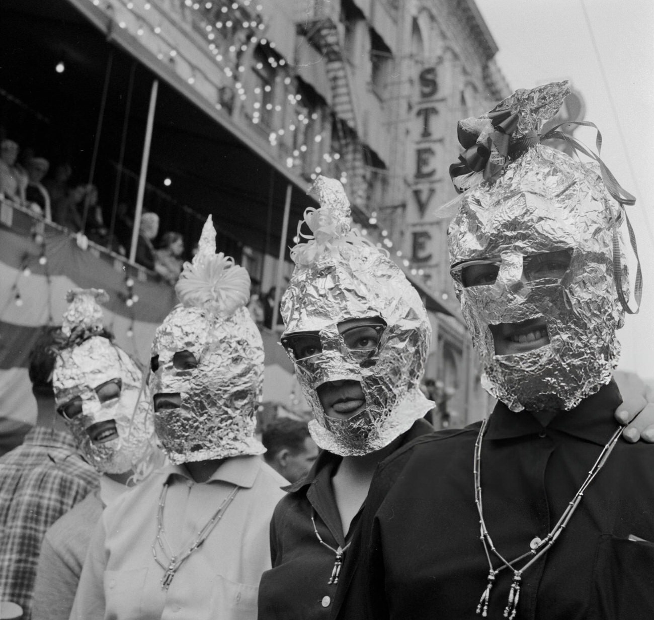 Among the Less Spectacular of the Costumes at the New Orleans Mardi Gras Are These Homemade Tin Foil Balaclavas, 1950s.