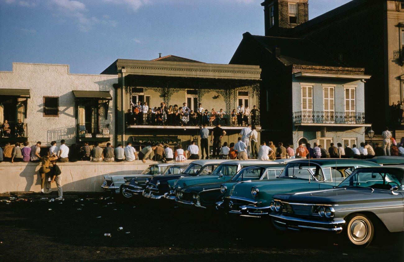 People Gather on a Balcony and on a Wall During Mardi Gras in New Orleans, 1961.