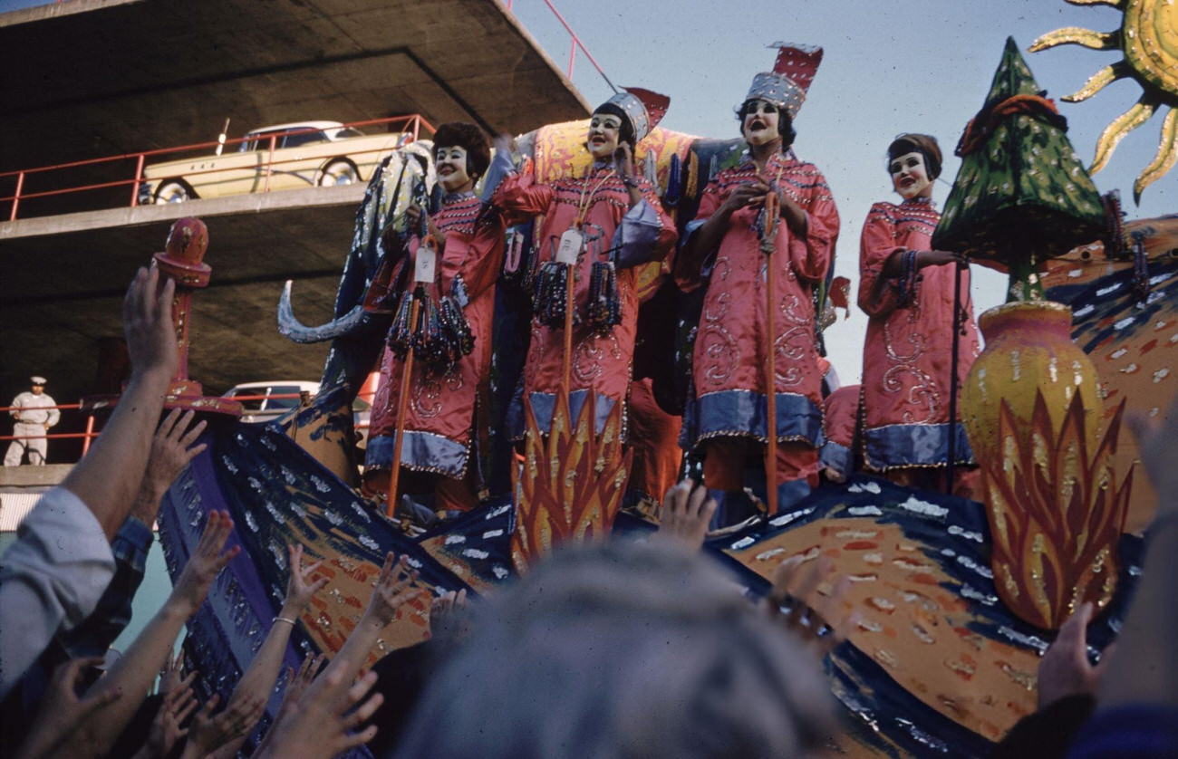 Figures on a Float Being Greeted by the Crowd in a Mardi Gras Procession in New Orleans, 1961.