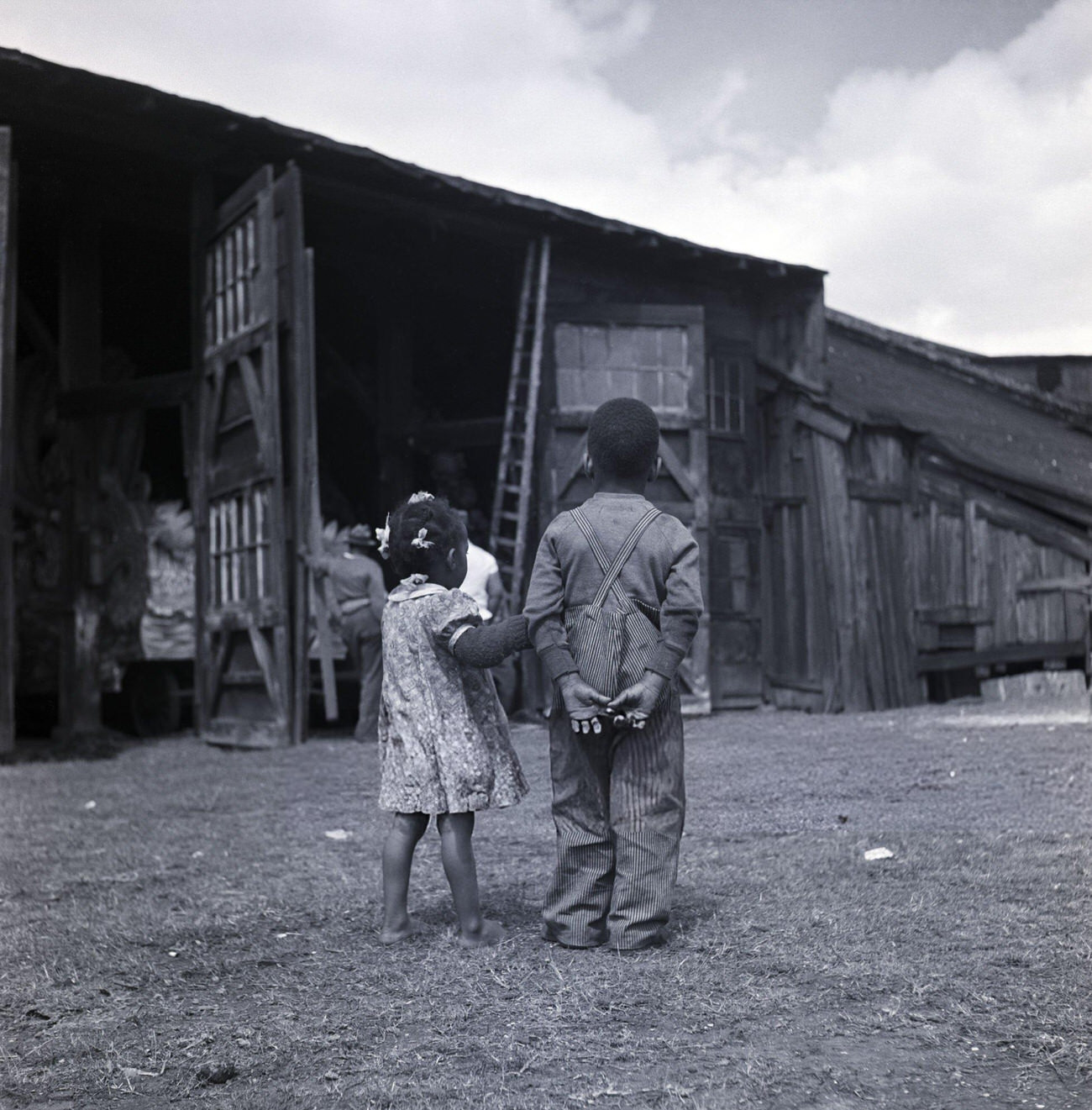 Young Children Watching Men Bring Mardi Gras Parade Floats Out of Storage in New Orleans, 1940s.