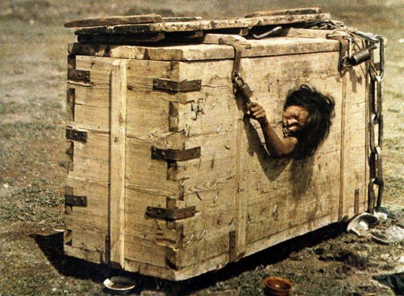 National Geographic magazine published this shot with a description: "A Mongolian woman sentenced to starvation death", though this box could be used just as a portable prison popular among nomadic people.