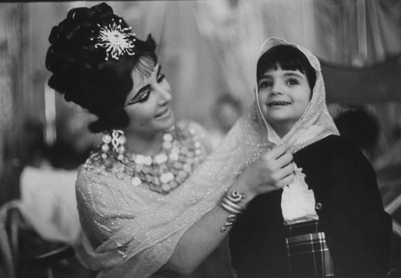 Liz Taylor playing with her daughter, Liza, while filming Cleopatra in Rome, 1962.