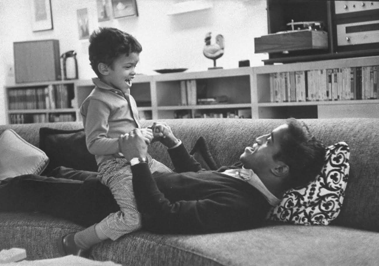 Sammy Davis Jr. playing with his son, Mark Davis, 1964.