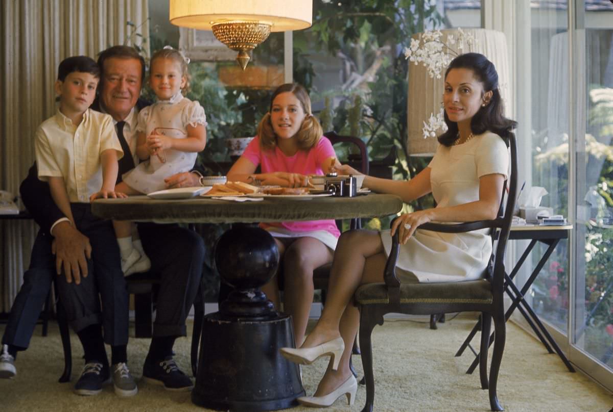 John Wayne with his children, Ethan, Marissa, and Aissa, and wife Pilar, 1969.