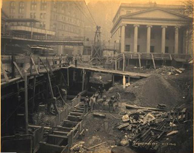 Subway Construction: Park Row and City Hall Park, from street level. Church with Ionic columns at right. November 1902.