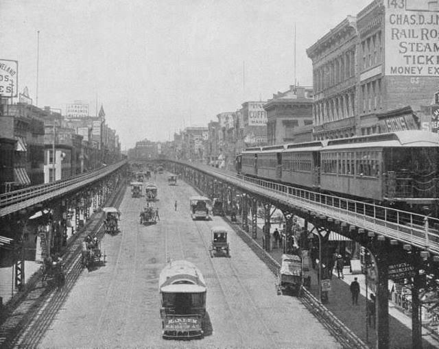 3rd Ave line of the Manhattan Elevated Railway running on tracks constructed alongside the Bowery which is being utilized by both horse drawn and mechanical traffic