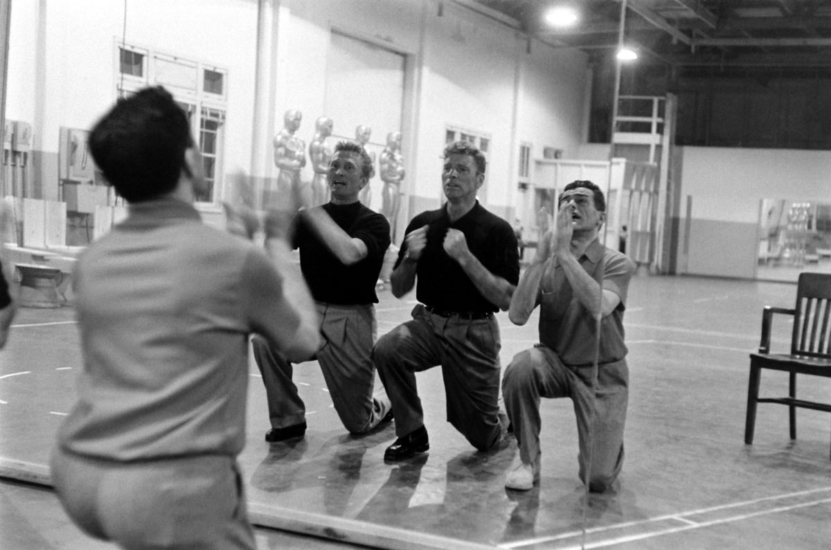 Kirk Douglas and Burt Lancaster with choreographer Jack Cole, practicing a mock-bitter song-and-dance number called “It’s Great Not to Be Nominated”; the tune ribbed many of the year’s Oscar contenders.