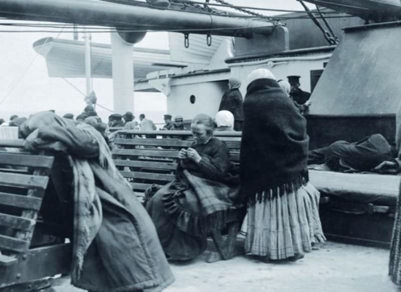 Passengers from steerage settle on deck aboard the Titanic.