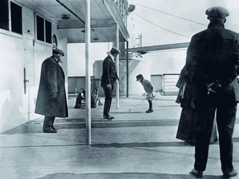 A boy plays aboard the deck of the Titanic.