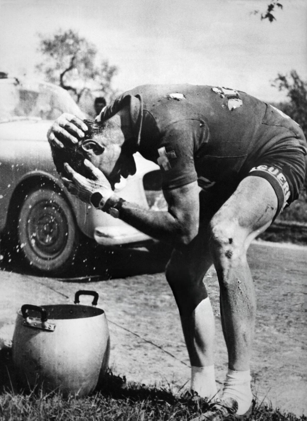 Hugo Koblet refreshing his head after a fall during the Tour d'Italie, 1953.