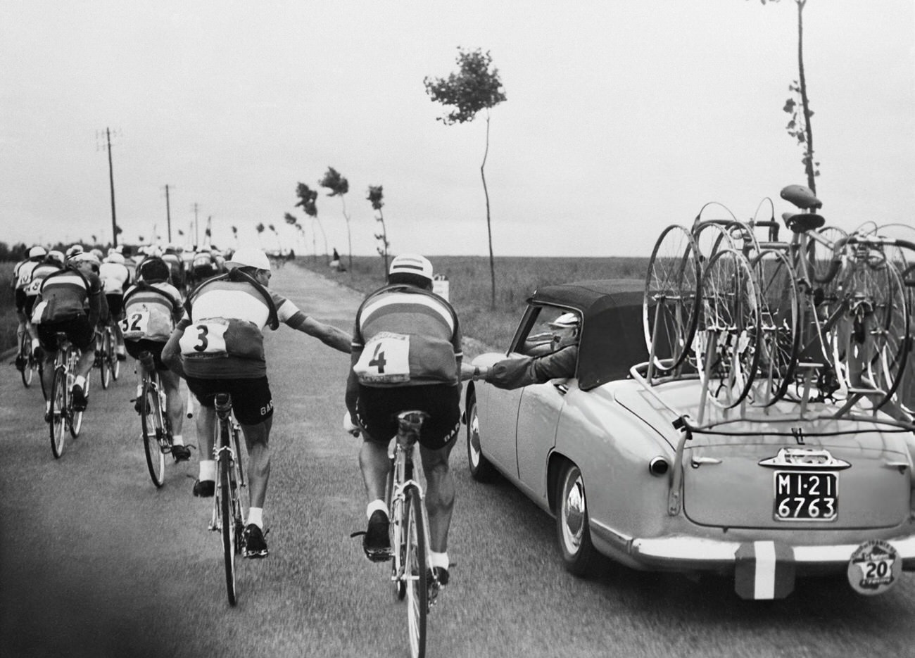 Gino Bartali tightening his handlebars during the Tour de France, 1953.