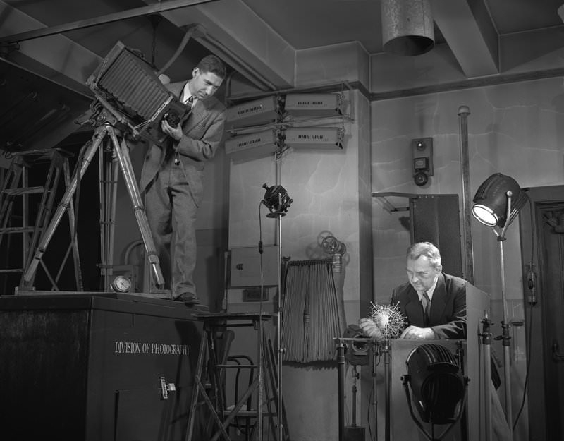 Glass blower Herman O. Mueller and photographer Charles H. Coles, photographing radiolarian