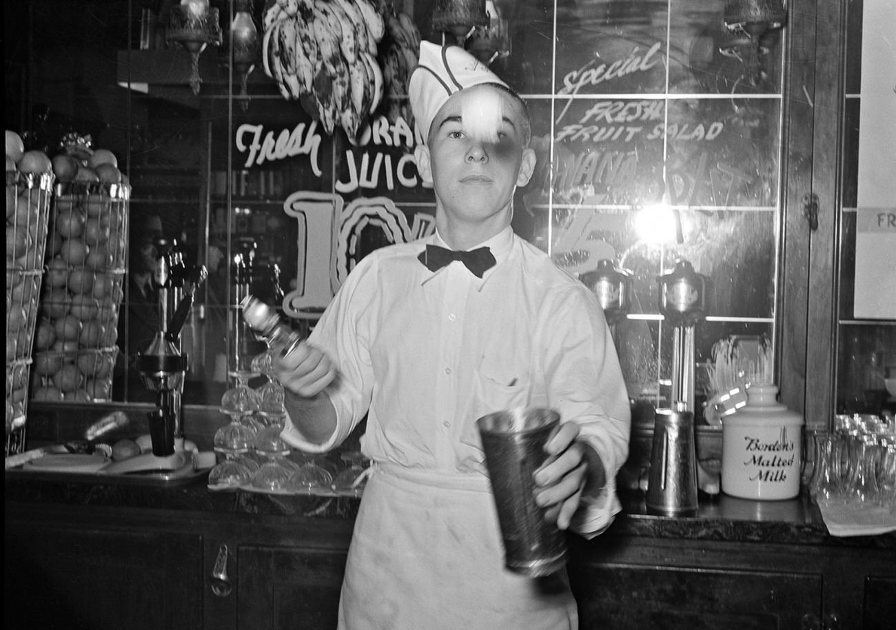 A soda jerk making malted milk shakes in Corpus Christi, Texas, 1939.