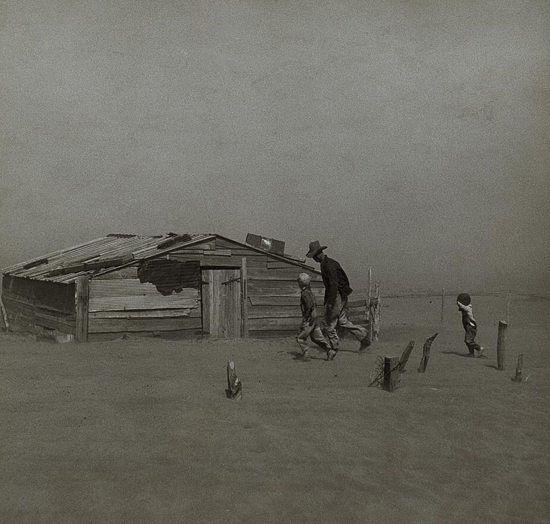 Farmers and sons walking during a dust storm in Cimarron County, Oklahoma, 1936.