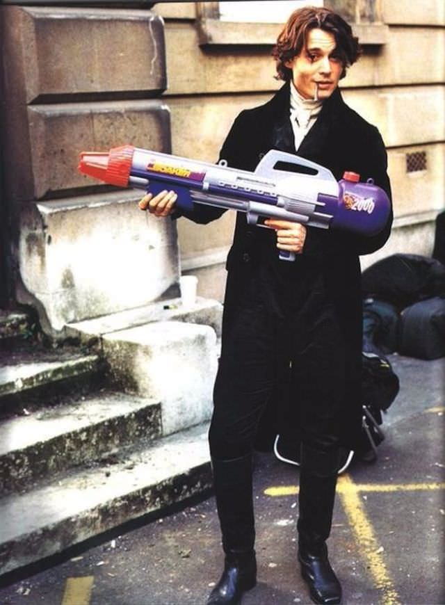 Johnny Depp smoking a blunt and holding a super-soaker on the set of “Sleepy Hollow”