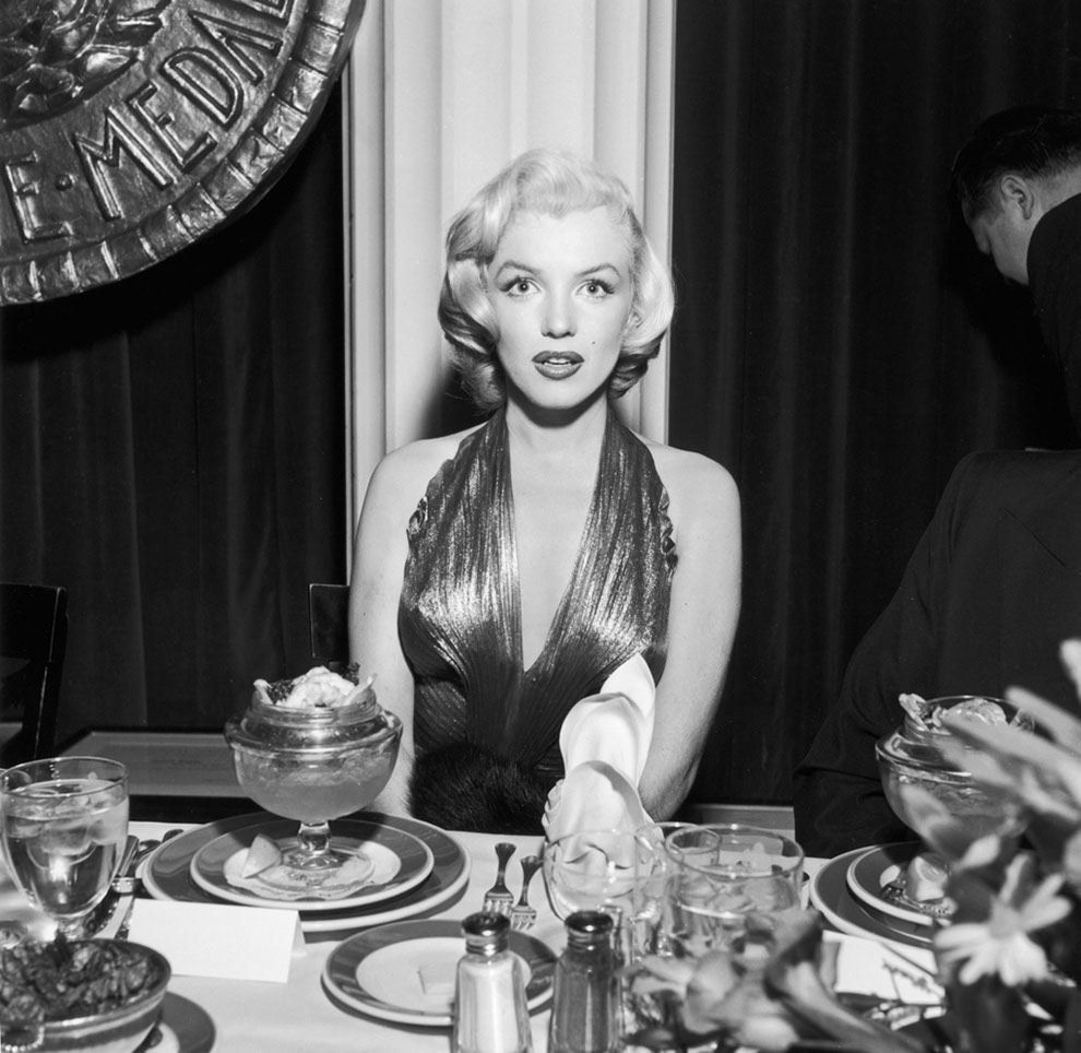 Marilyn Monroe ignoring her dessert. At a banquet table during a Photoplay Gold Medal Awards dinner, 1953.