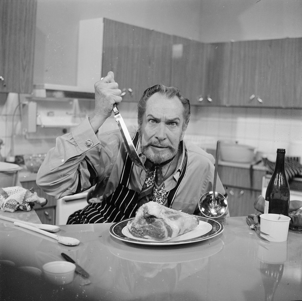 Vincent Price murdering a piece of meat.At Thames TV studios in London, 1970.