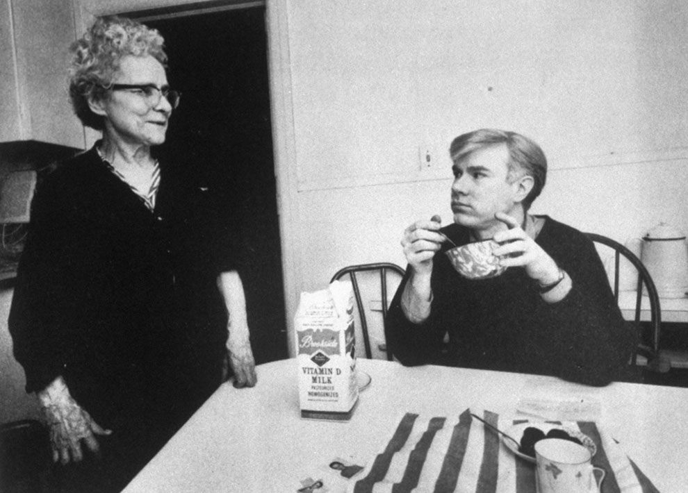 Andy Warhol starting the day with cereal. With his mother Julia, 1964.