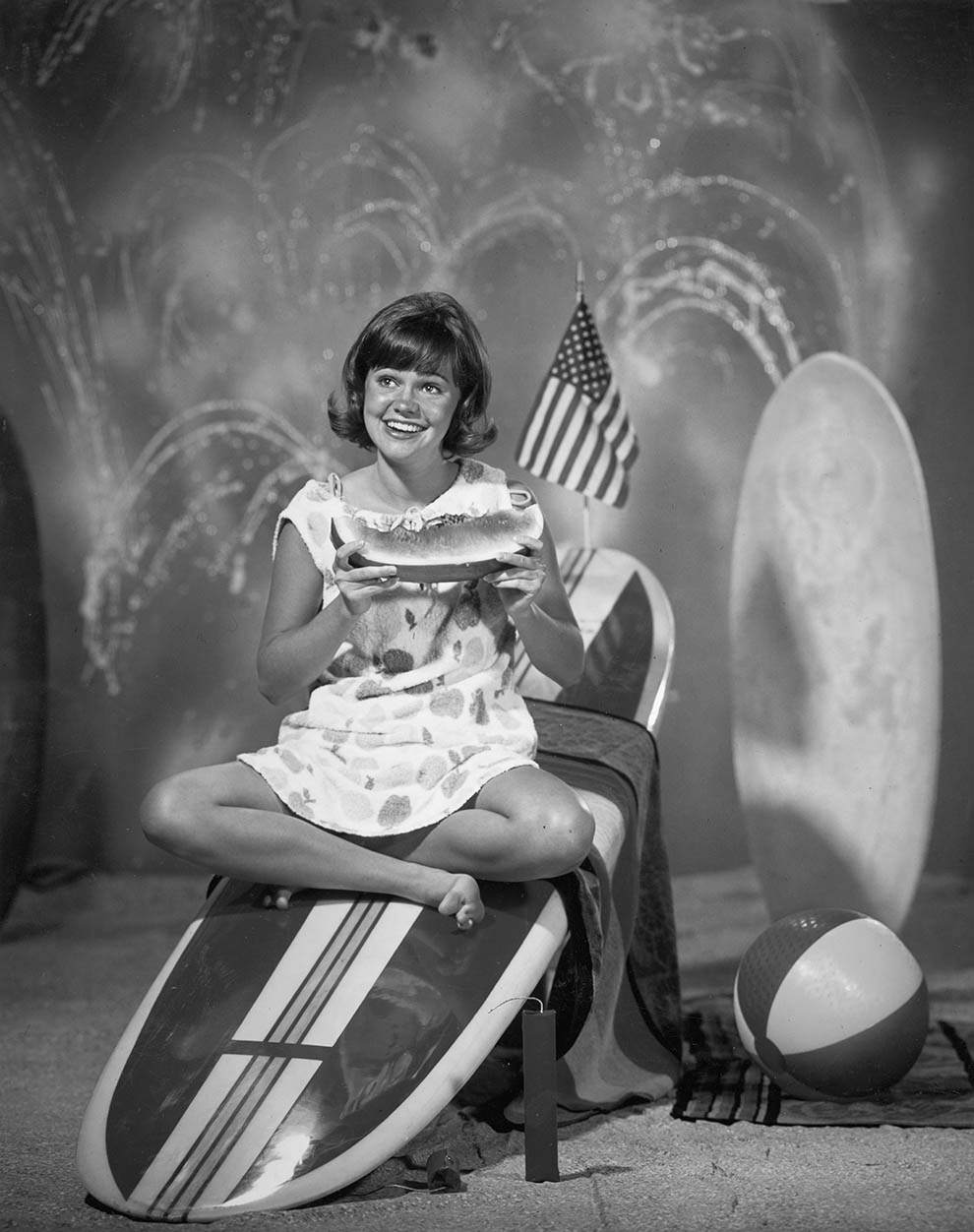 Sally Field eating watermelon on a surfboard. For the television series 'Gidget,' 1965.