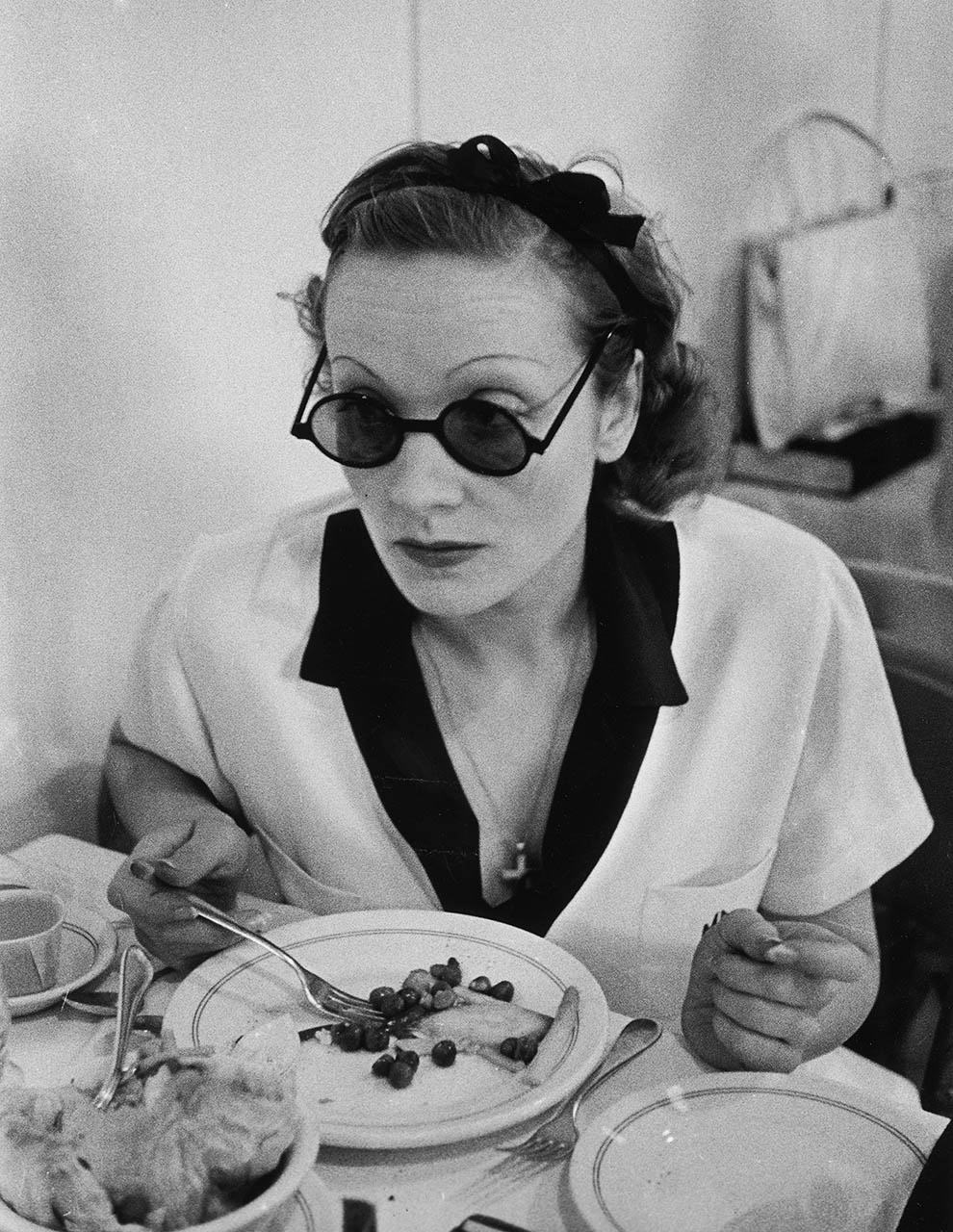 Marlene Dietrich eating lunch. At the Paramount commisary, 1938.