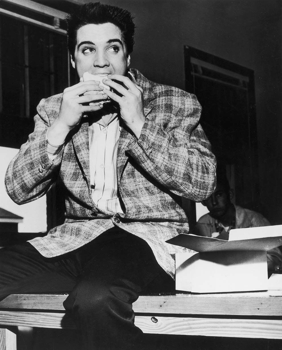 Elvis Presley eating a sandwich. Memphis, Tennessee, 1958.